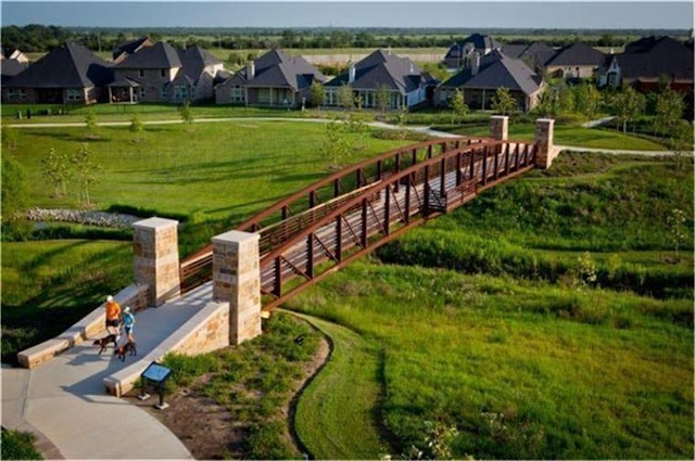 view of home's community with a yard