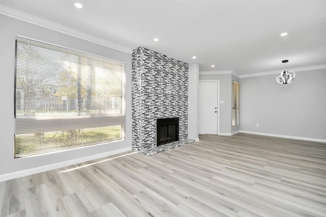 unfurnished living room featuring a fireplace, light wood-type flooring, and ornamental molding