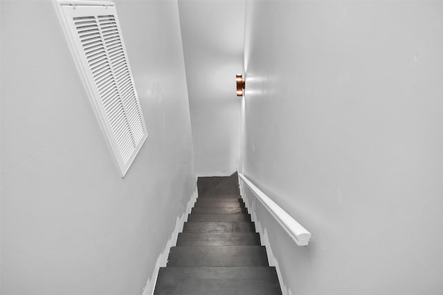 stairway featuring wood-type flooring