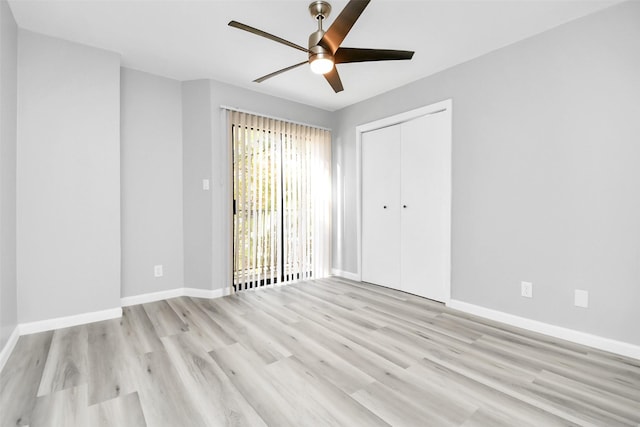 unfurnished bedroom featuring ceiling fan, a closet, and light hardwood / wood-style floors