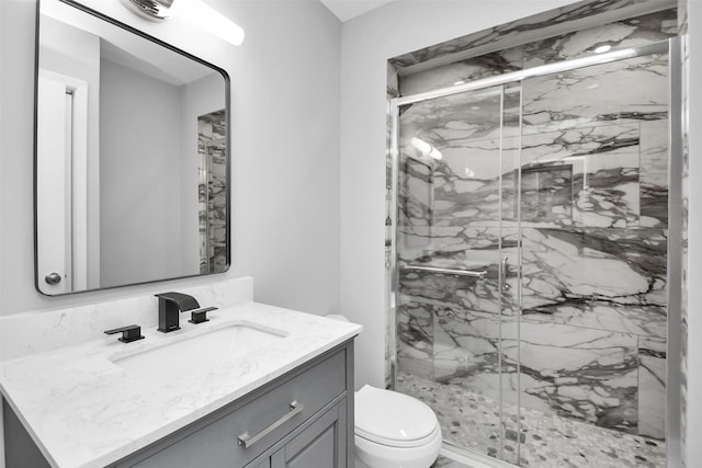 bathroom with vanity, an enclosed shower, and toilet