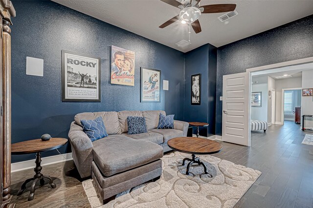 living room with wood-type flooring and ceiling fan