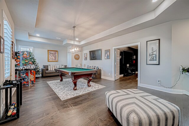 game room featuring a notable chandelier, dark wood-type flooring, billiards, and a tray ceiling