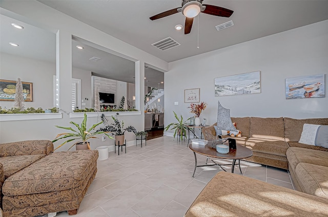 tiled living room with ceiling fan