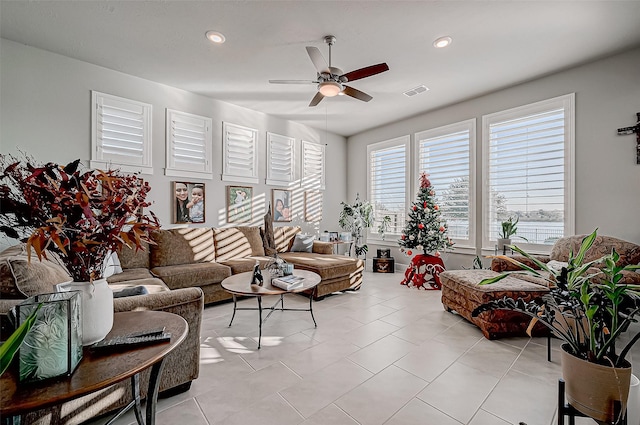 living room featuring ceiling fan and light tile patterned floors