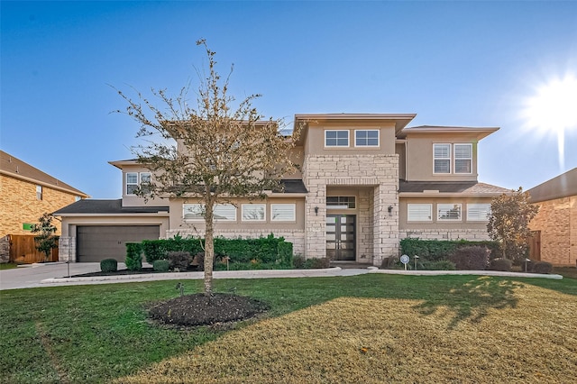 view of front facade featuring stone siding, a front lawn, concrete driveway, and stucco siding