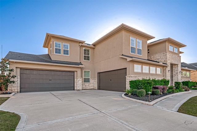 view of front of home with a garage, concrete driveway, stone siding, and stucco siding