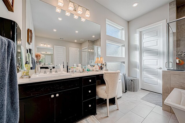 bathroom with plus walk in shower, vanity, and tile patterned flooring