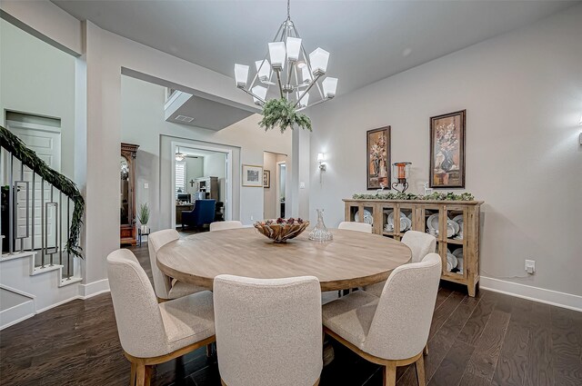 dining room with a chandelier and dark wood-type flooring