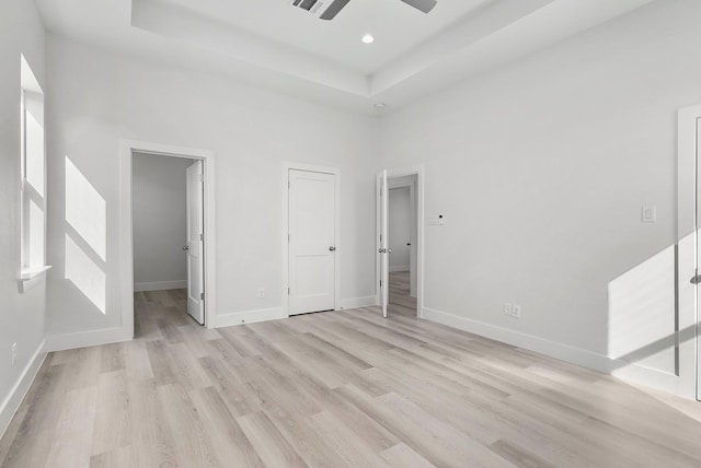 22803 Miramar Dr, Galveston, TX 77554 - unfurnished bedroom with light wood-style floors, a tray ceiling, a ceiling fan, and recessed lighting