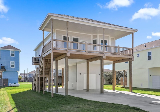 22803 Miramar Dr, Galveston, TX 77554 - rear view of property with an attached garage, a carport, a lawn, driveway, and a wooden deck