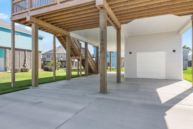 22803 Miramar Dr, Galveston, TX 77554 - view of patio featuring stairs, driveway, and an attached garage