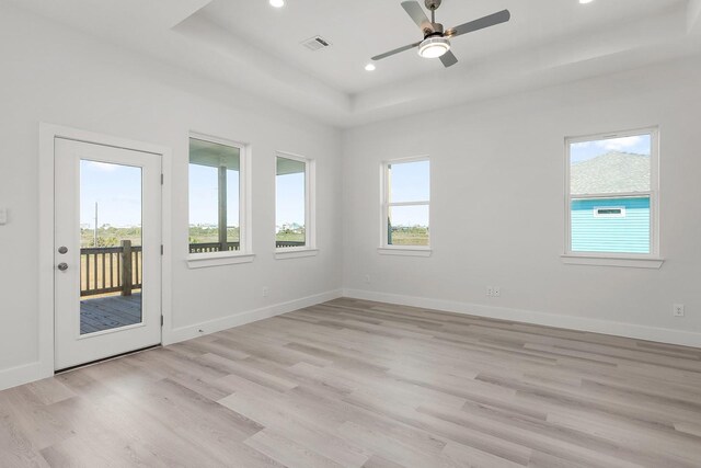 22803 Miramar Dr, Galveston, TX 77554 - empty room featuring light wood-style flooring, a tray ceiling, a ceiling fan, and recessed lighting