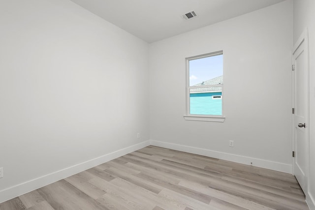 spare room featuring light hardwood / wood-style flooring