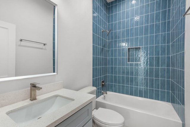 full bathroom with vanity, toilet, and tiled shower / bath