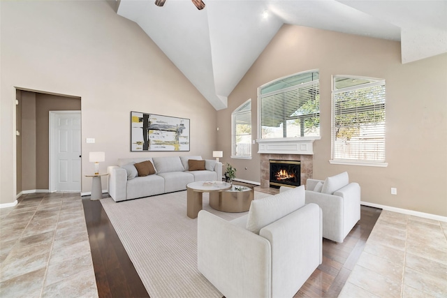 living room with ceiling fan, a fireplace, and hardwood / wood-style flooring