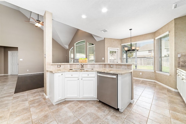 kitchen featuring pendant lighting, dishwasher, white cabinets, sink, and vaulted ceiling