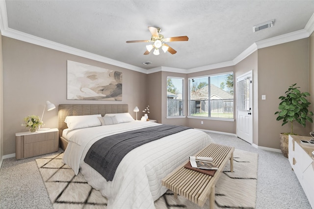 carpeted bedroom with ceiling fan and crown molding