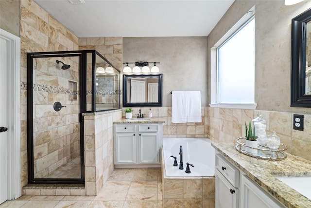 bathroom featuring vanity and separate shower and tub