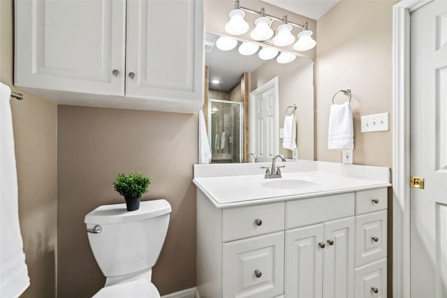 bathroom featuring vanity, toilet, and walk in shower