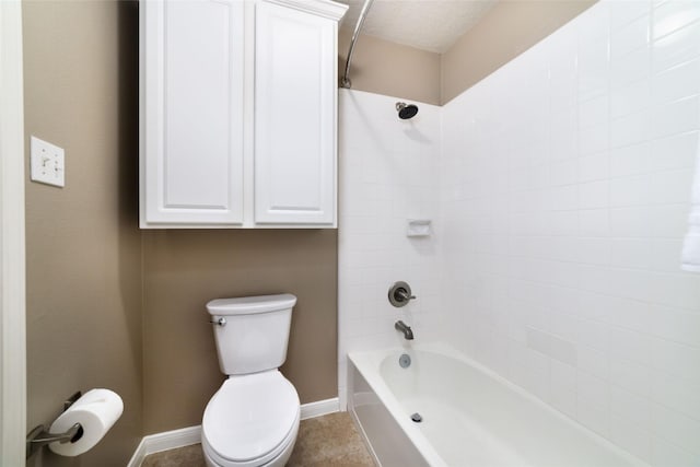 bathroom featuring washtub / shower combination, tile patterned floors, and toilet