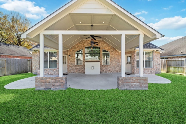 rear view of house featuring a yard, ceiling fan, and a patio area