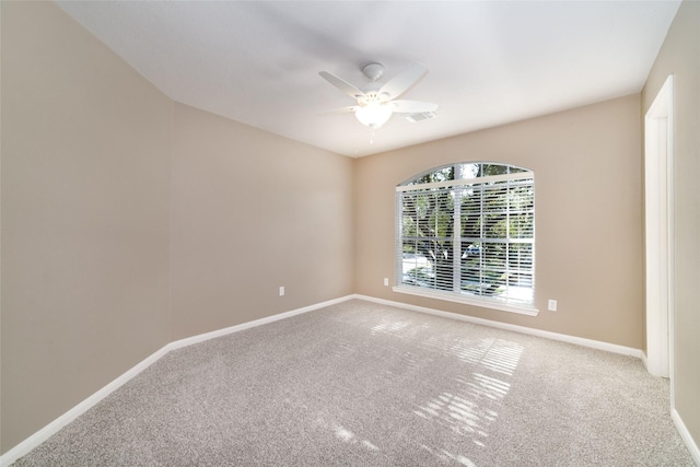 unfurnished room featuring ceiling fan and carpet floors