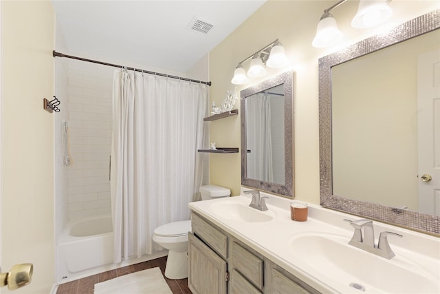 full bathroom with vanity, shower / tub combo with curtain, and toilet