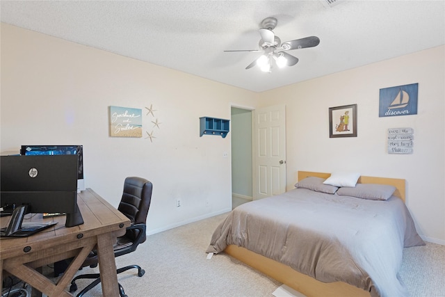 bedroom with a textured ceiling, ceiling fan, and carpet