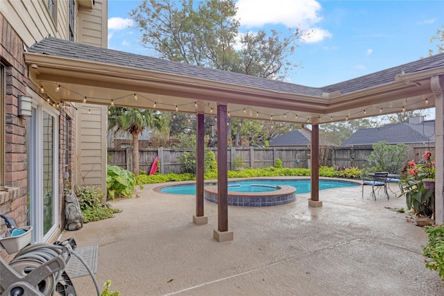 view of patio with a pool with hot tub