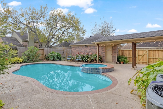 view of swimming pool featuring an in ground hot tub and a patio area