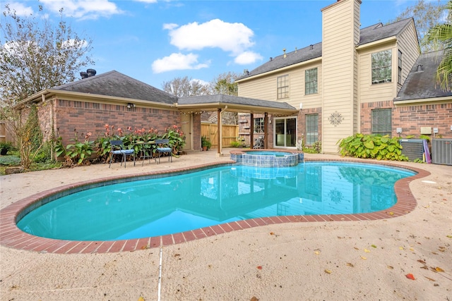 view of pool with an in ground hot tub and a patio area