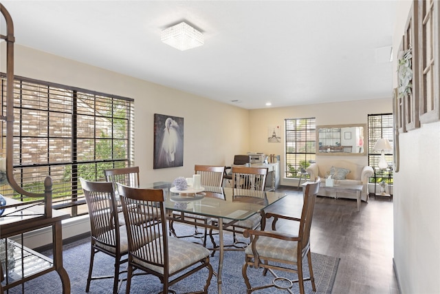 dining space with a healthy amount of sunlight and dark hardwood / wood-style flooring