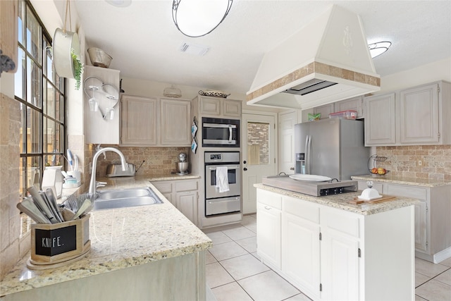 kitchen featuring light tile patterned flooring, a kitchen island, sink, custom exhaust hood, and stainless steel appliances