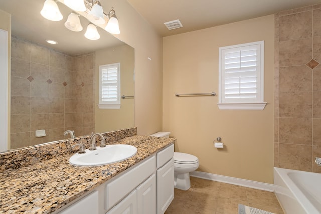 bathroom with tile patterned flooring, vanity, and toilet