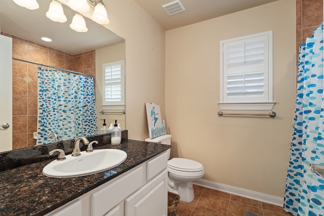 bathroom featuring tile patterned flooring, vanity, a shower with shower curtain, and toilet