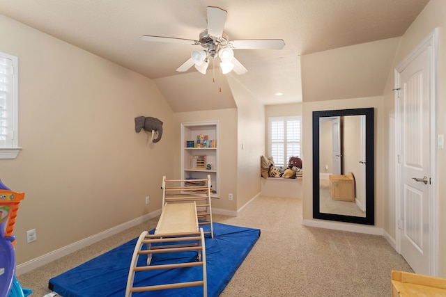 rec room featuring light carpet, vaulted ceiling, and ceiling fan