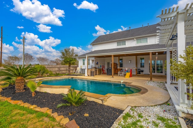 view of swimming pool featuring an outdoor kitchen, a patio, and a pergola