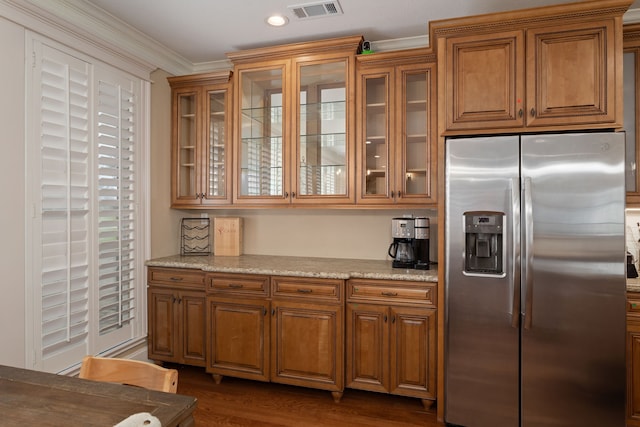 kitchen featuring stainless steel fridge, light stone countertops, dark hardwood / wood-style floors, and ornamental molding