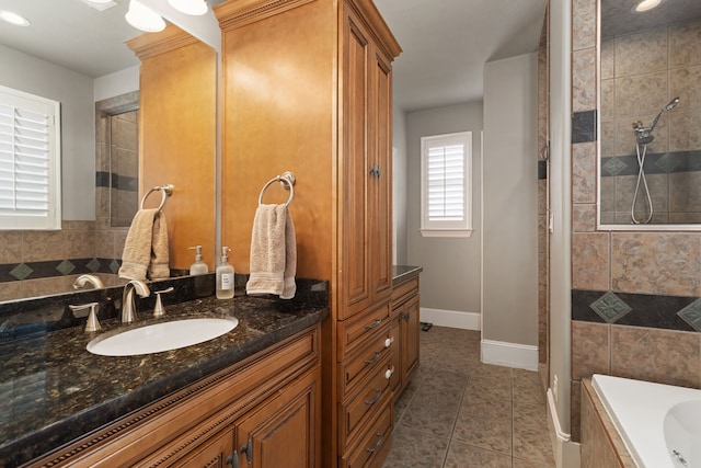 bathroom with tile patterned flooring, vanity, and separate shower and tub