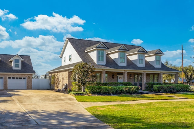 cape cod house featuring a front yard and covered porch