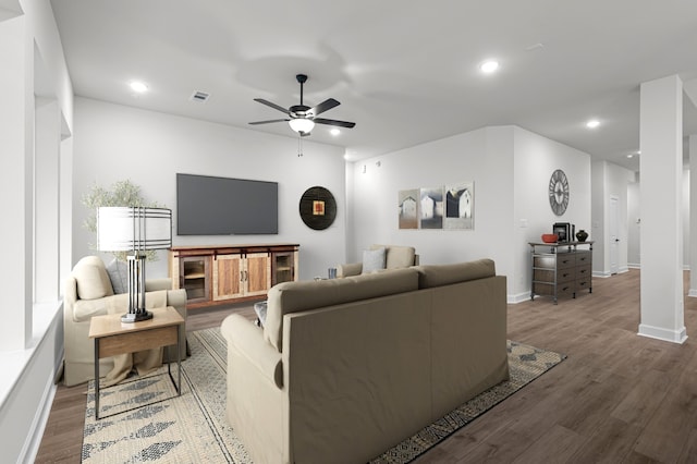 living room with hardwood / wood-style flooring and ceiling fan