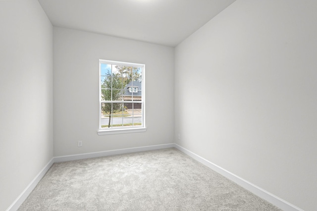 unfurnished room featuring light colored carpet