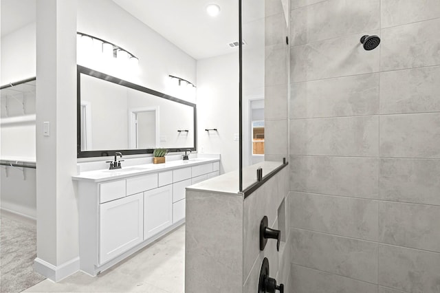 bathroom with walk in shower and vanity