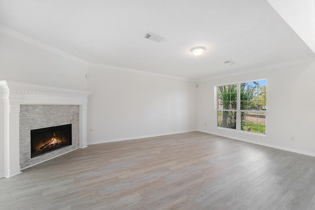 unfurnished living room featuring a fireplace, light hardwood / wood-style flooring, and ornamental molding