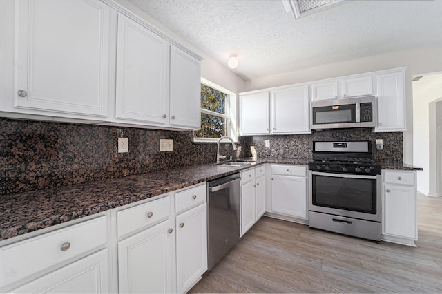 kitchen featuring white cabinets and appliances with stainless steel finishes