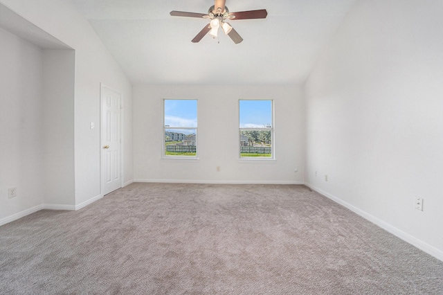 unfurnished room with ceiling fan, light colored carpet, and vaulted ceiling