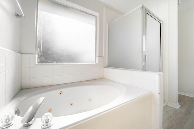 bathroom featuring separate shower and tub