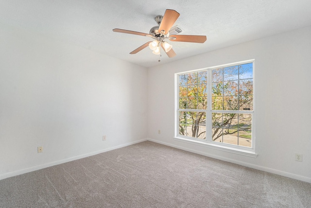 unfurnished room featuring carpet flooring, ceiling fan, and a textured ceiling