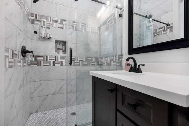 bathroom featuring vanity, a shower with door, and tile walls